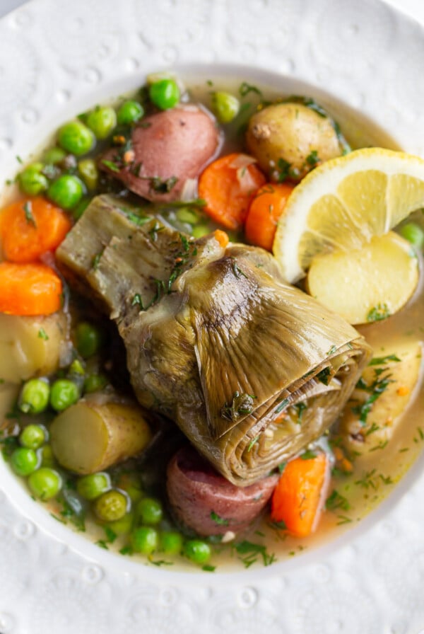 artichokes constantinople- steamed artichoke in a veggie stew with a lemon wedge