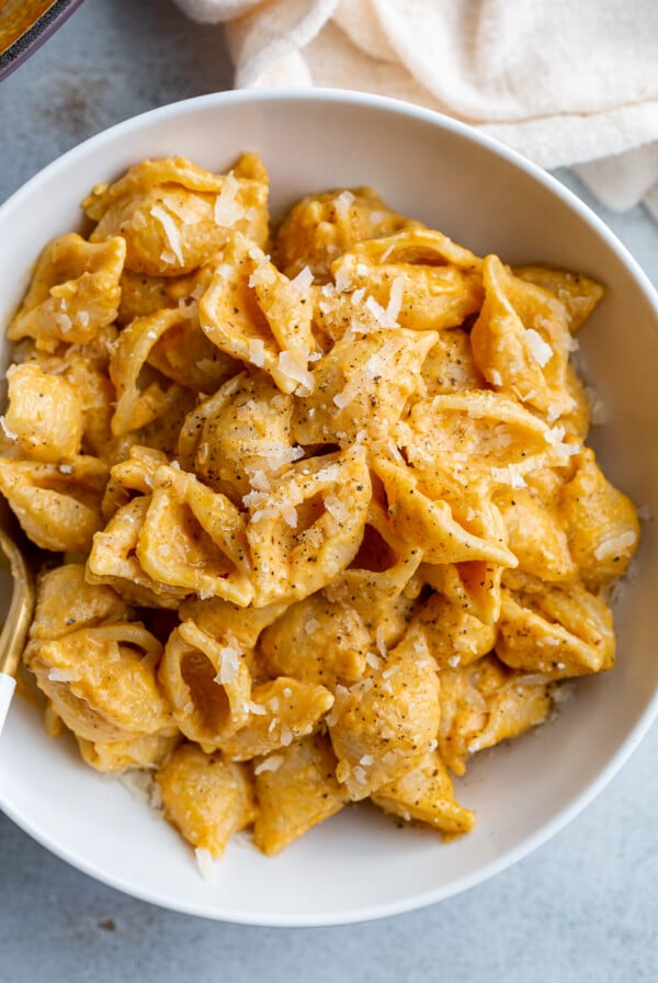 creamy pumpkin macaroni pasta with shredded parmesan on top