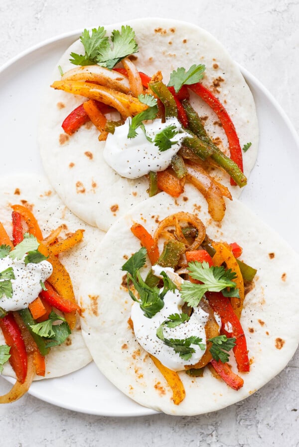 Fajitas made with flour tortillas, veggies, sour cream and cilantro.